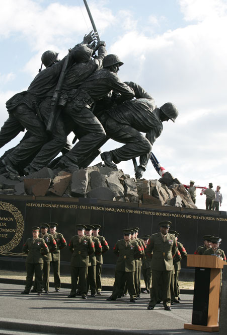 Marines prepare to raise a new flag over the United States Marine Corps War Memorial.