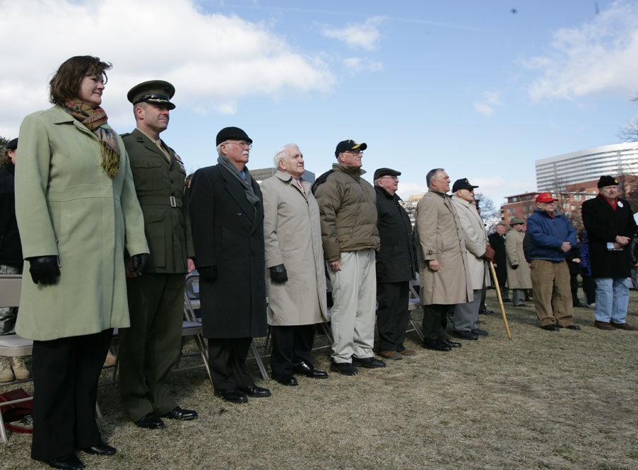 (From left) Col and Mrs. William K. Lietzau, Medal of Honor Marine Col Harvey C. “Barney” Barnum, USMC (Ret), Benjamin Alfano, John Boes, Col John B. Donovan, USMC (Ret.), Joseph Westner and Maj Norman T. Hatch, USMC (Ret) stood to pay tribute during the ceremony.